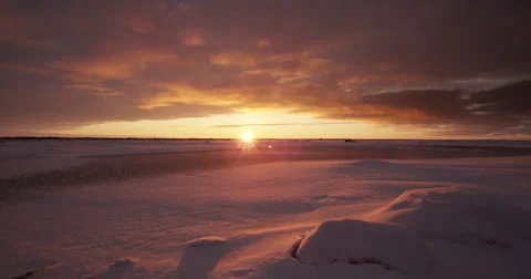 Time lapse of clouds rushing over tundra at sunset with snow Stock Footage 67822736