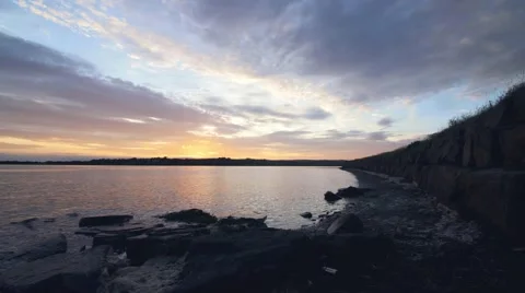 Time lapse of clouds setting over water Stock-Footage 66776874