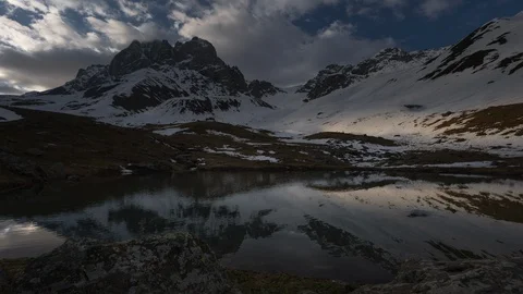 Time-lapse of clouds, snow-capped mountains and a lake Stock Footage 114403135