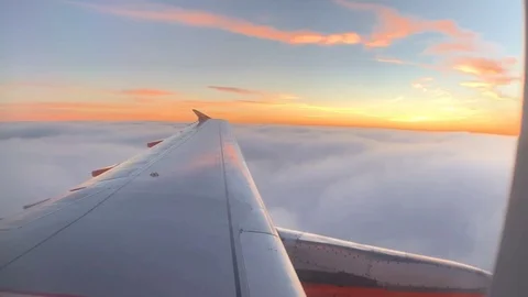 Time lapse of clouds at Sunset out of airplane window Stock Footage 104625688