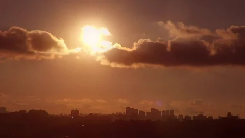 Time Lapse clouds at sunset over city Stock Footage 76104009