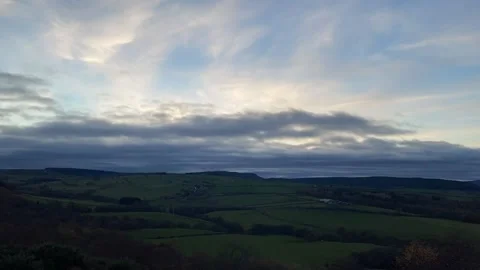 Time Lapse Clouds at Sunset Over Hills Stock Footage