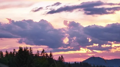 Time lapse clouds at sunset over trees, timelapse 4K Video stock 210233158
