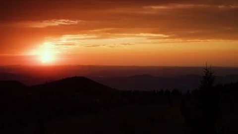 Time-lapse of clouds in the sunset sky over the mountain ranges Stock Footage 103402080