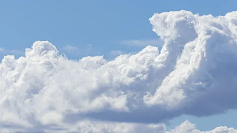 Time lapse: Clouds swirling in the blue sky on a summer day Stock Footage 137931734