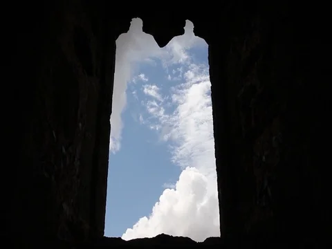 Time lapse of clouds though a ruined church window Stock Footage