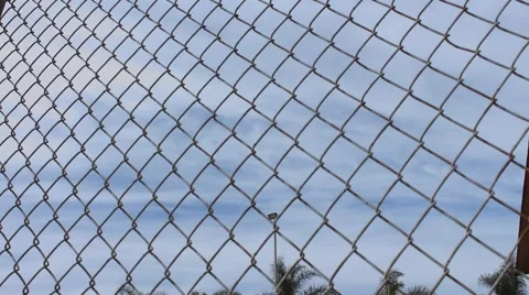 Time Lapse Clouds Through Fence Lines Stock Footage 48827563