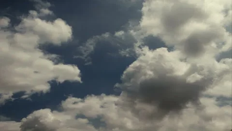 Time lapse clouds travel across a dark blue sky Stock Footage 246172248