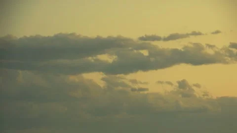 Time lapse clouds travel across a sunsetting sky Stock Footage 246172353