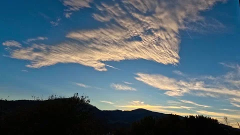 Time lapse of clouds turning orange Stock Footage 318394373