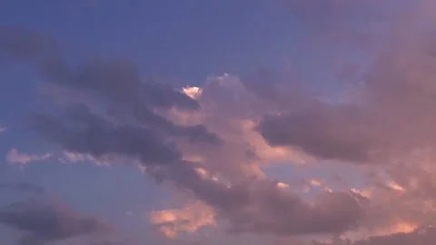 Time lapse clouds with warm sunset light on blue sky Stock Footage 138842675