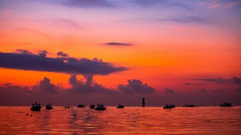 Time Lapse - Cloudscape above the Ocean Horizon with the Boats at Dawn - 4K Stock Footage 101700862