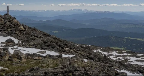 Time lapse of cloudscape behind of the mountains top. Snow, rocks, cliffs and Stock Footage 118733642