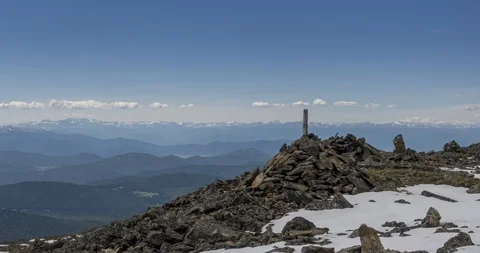 Time lapse of cloudscape behind of the mountains top. Snow, rocks, cliffs and Stock Footage 119120425