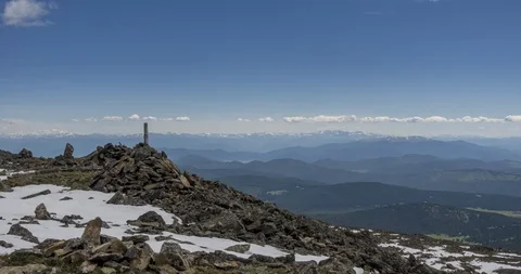 Time lapse of cloudscape behind of the mountains top. Snow, rocks, cliffs and Stock Footage 128232685