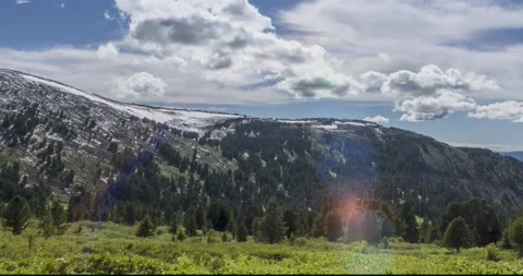 Time lapse of cloudscape behind of the mountains top. Snow, rocks, cliffs and Stock Footage 143727326
