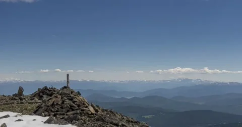 Time lapse of cloudscape behind of the mountains top. Snow, rocks, cliffs and Stock Footage 151296853
