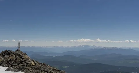 Time lapse of cloudscape behind of the mountains top. Snow, rocks, cliffs and Stock Footage 152995495