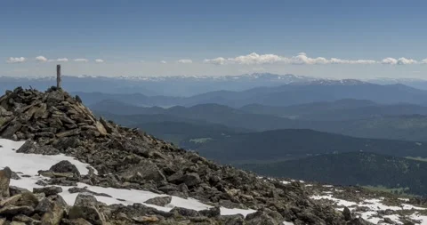 Time lapse of cloudscape behind of the mountains top. Snow, rocks, cliffs and Stock Footage 154560558