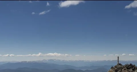 Time lapse of cloudscape behind of the mountains top. Snow, rocks, cliffs and Stock Footage 158900062