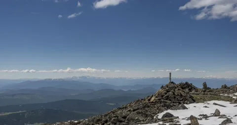 Time lapse of cloudscape behind of the mountains top. Snow, rocks, cliffs and Stock Footage 160671948