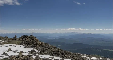Time lapse of cloudscape behind of the mountains top. Snow, rocks, cliffs and Stock Footage 162776344