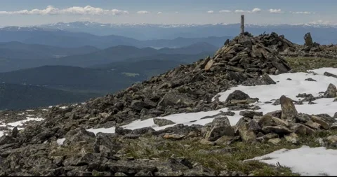 Time lapse of cloudscape behind of the mountains top. Snow, rocks, cliffs and Stock Footage 164722874