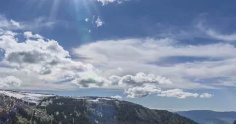 Time lapse of cloudscape behind of the mountains top. Snow, rocks, cliffs and Stock Footage 170328597