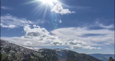 Time lapse of cloudscape behind of the mountains top. Snow, rocks, cliffs and Stock Footage 196741934