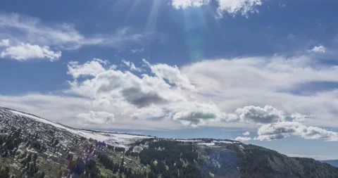 Time lapse of cloudscape behind of the mountains top. Snow, rocks, cliffs and Stock Footage 225830826