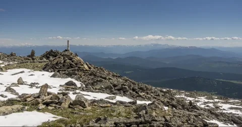 Time lapse of cloudscape behind of the mountains top. Snow, rocks, cliffs and Stock Footage 265131587