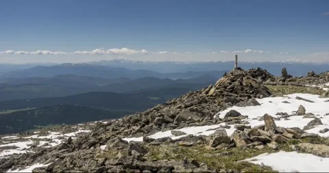 Time lapse of cloudscape behind of the mountains top. Snow, rocks, cliffs and Stock Footage 274521120
