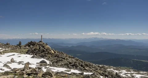 Time lapse of cloudscape behind of the mountains top. Snow, rocks, cliffs and Stock Footage 278510917