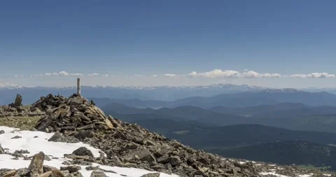 Time lapse of cloudscape behind of the mountains top. Snow, rocks, cliffs and Stock Footage 307574618