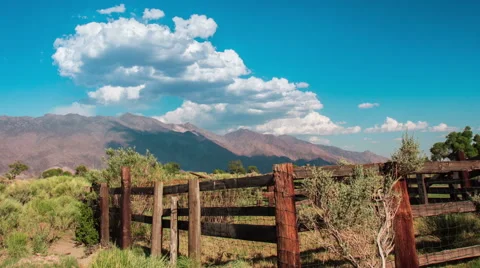 Time Lapse - Cloudscape Moving Over Mountains with Ranch Stock Footage 52492331