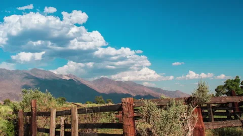 Time Lapse - Cloudscape Moving Over Mountains with Ranch, panning Stock Footage 53090415