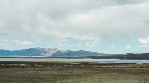 Time Lapse - Cloudscape Moving Over Mountains with River, panning view Stock Footage 53090709