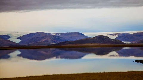 Time Lapse - Cloudscape over Snowcapped Mountains with Reflection on the River Video stock 69871158