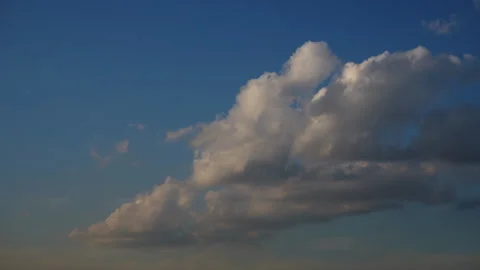 Time-lapse of cloudscapes transform across a bright blue sky Video stock 296206758