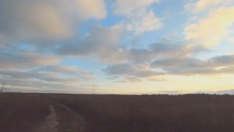 Time lapse of cloudy fields with rays of light over a field in late autumn. Stock Footage 121521235