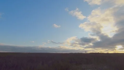 Time lapse of cloudy fields with rays of light over a field in late autumn. Stock Footage 121791202