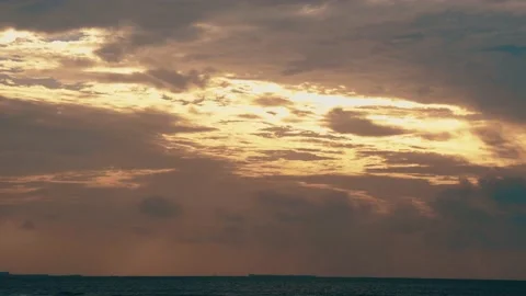 Time Lapse Cloudy Moving Fast with Warm Sun Light Pass Through on the sea Video stock 153591129