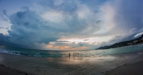 Time Lapse - Cloudy skies above the sea and waves on the dock Stock Footage 88479574
