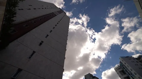 Time lapse of cloudy sky and a tall building in a sunny day Stock Footage 108873970