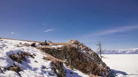 Time lapse cloudy sky on background frozen snow Lake Baikal, clouds move winter Stock Footage 317302629