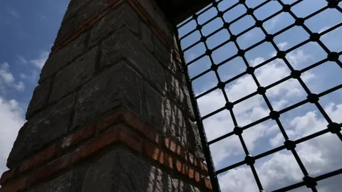 Time lapse cloudy sky in the windows of a historic building Stock Footage 241897202