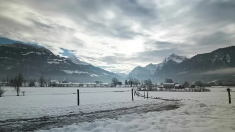 Time Lapse on a cloudy winter day in Switzerland, surrounded by huge mountains. Stock Footage 166551479