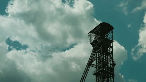 Time lapse of coal mine tower with fast moving clouds. Low angle shot. Stock Footage 116541150