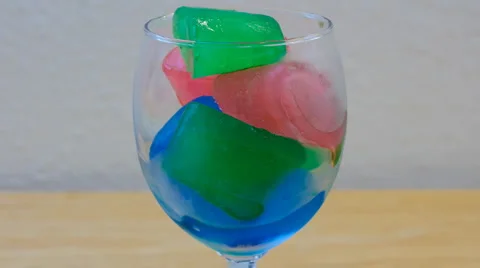 Time Lapse of Colored Ice Melting in Wine Glass Video stock 1202985