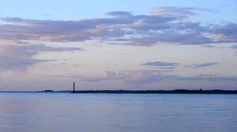 Time lapse of colorful clouds, lighthouse and water at sunset.mp4 Stock Footage 50069512